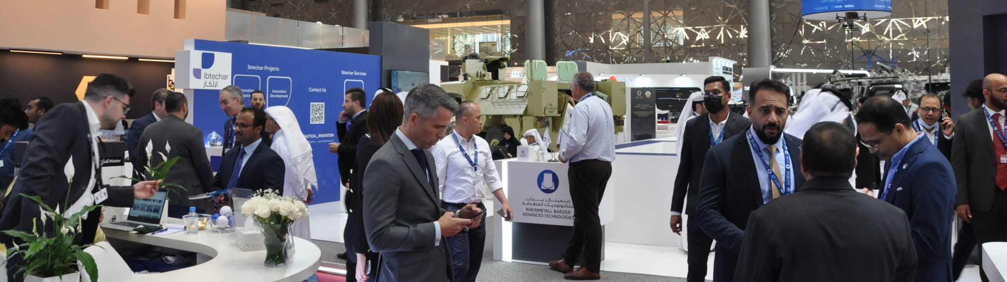Visitors and exhibitors meeting in Milipol Qatar's aisles and stands