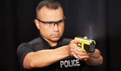 Guy holding a Taser 10 by Axon