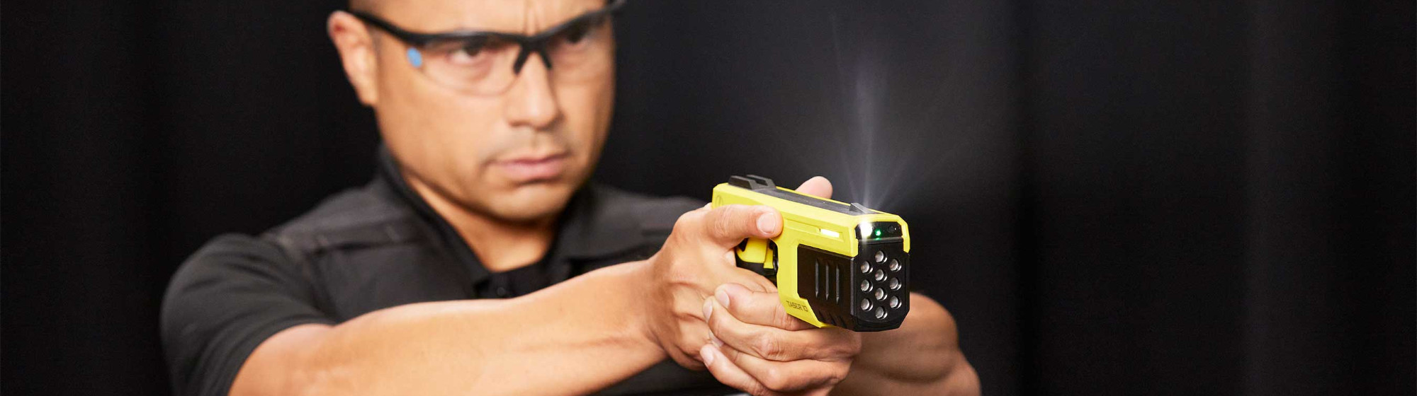 Guy holding a Taser 10 by Axon