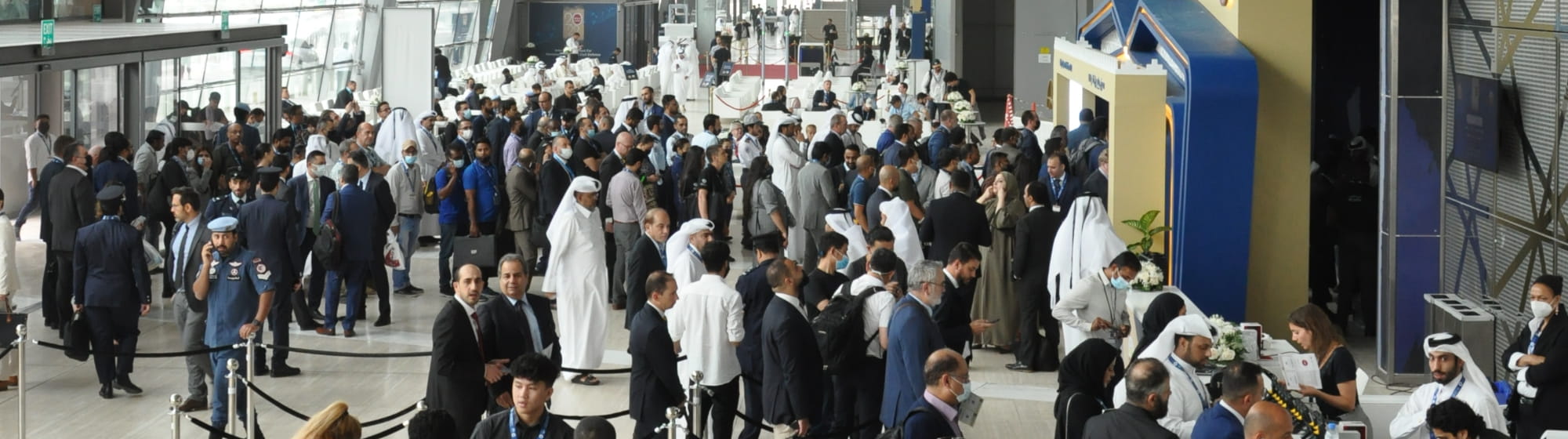 Entrance of Milipol Qatar with welcome desks for exhibitors and visitors