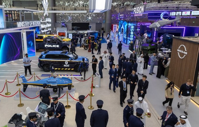 Overview of Milipol Qatar showcasing exhibition stands, police vehicles and security equipment.