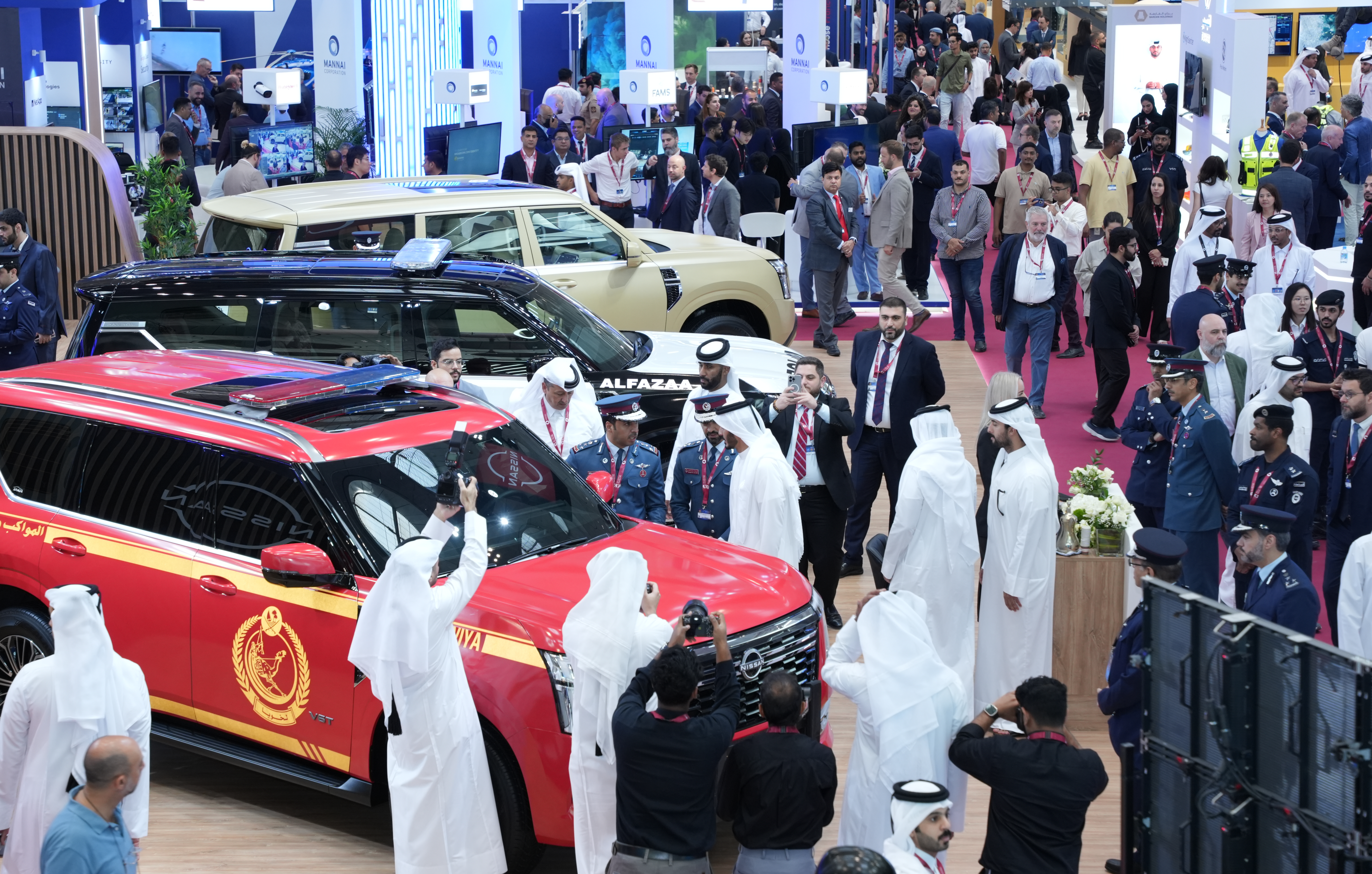 Several police SUV surrounded by visitors at Milipol Qatar 2024 exhibition
