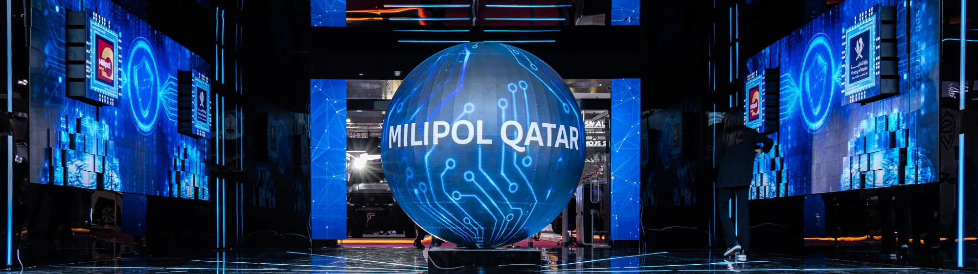 Giant digital sphere displaying “Milipol Qatar” in a futuristic blue scenography at the Milipol Qatar entrance