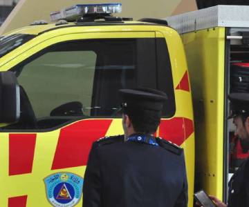 Officials in front of a civil defence vehicle at Milipol Qatar
