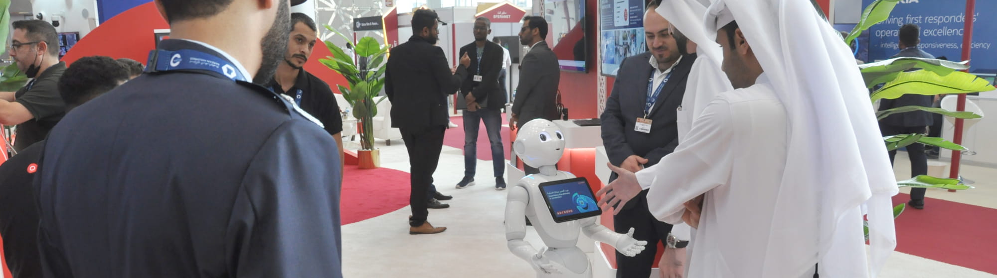 Visitors in an exhibitor stand with a robot in display