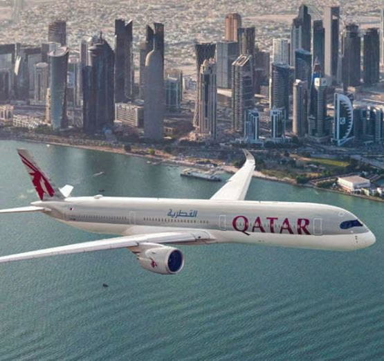 Qatar Airways plane above Doha's skyline